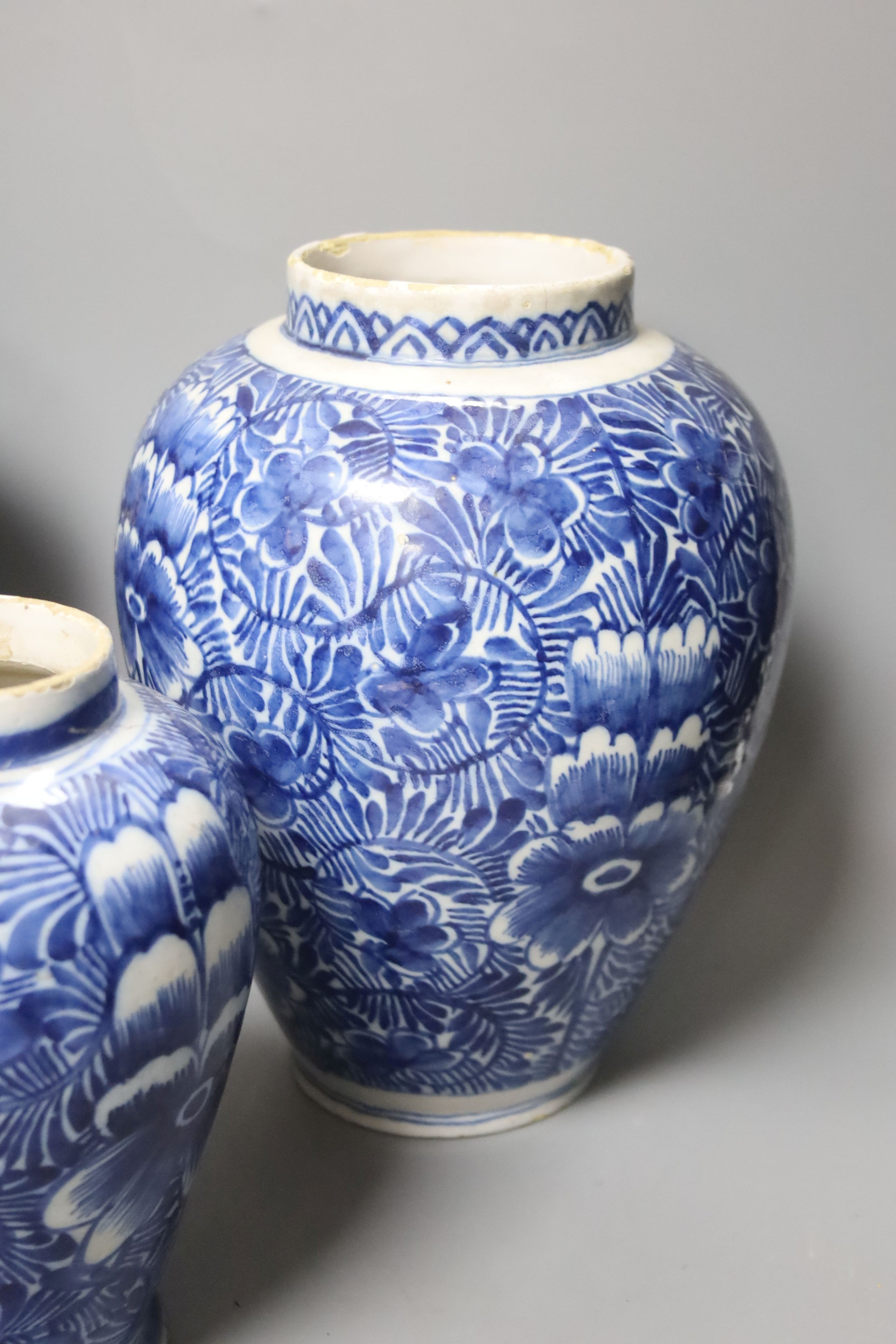 A pair of 18th century Dutch Delft blue and white oviform vases with floral decoration and two similar smaller vases, H 25cm & 19cm